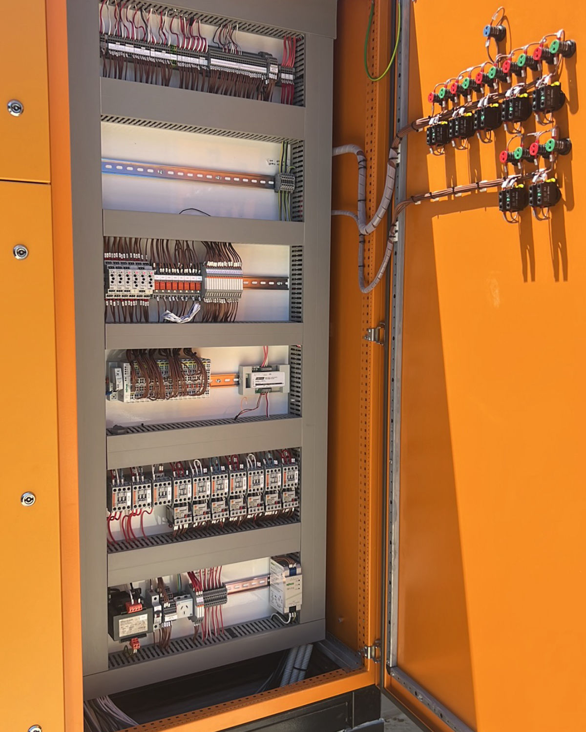 Completed motor control cabinet with contactor banks, protection devices and door-mounted control stations
